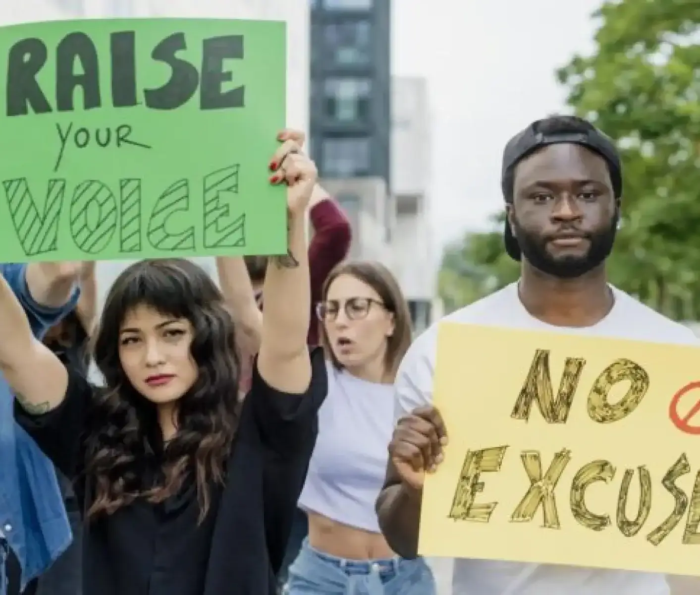 Jeunes tenant des pancartes « élevez la voix » écrit en anglais dans une manifestation